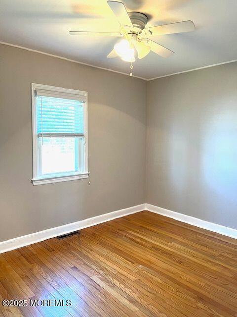 4 Cedar Avenue Waretown, NJ 08758 - Photo 12 of 15 a view of an empty room with wooden floor and a window