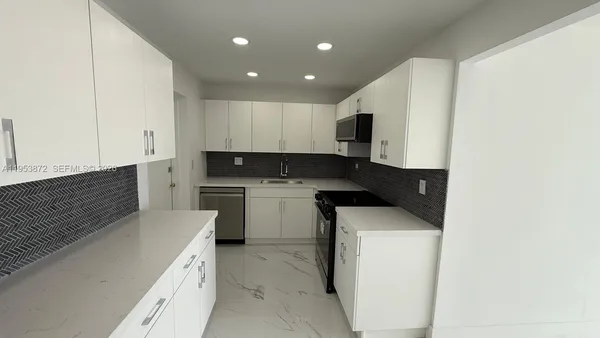 a kitchen with a sink a stove and refrigerator