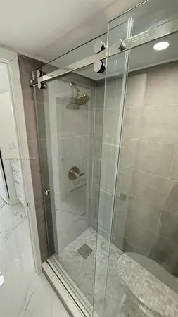 a bathroom with a shower and a sink