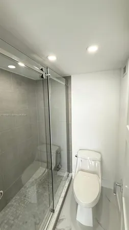 a bathroom with a toilet and a shower