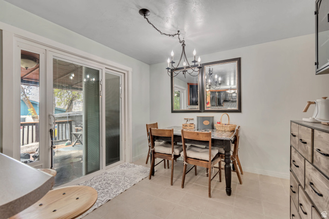 7470 Ramanee Drive Midvale, UT 84047 - Photo 10 of 29 Dining room with a chandelier and light tile patterned flooring