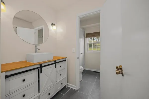 a bathroom with a sink a vanity and a mirror