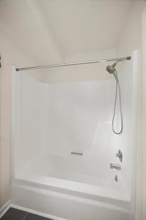 a bathroom with a shower and a bath tub