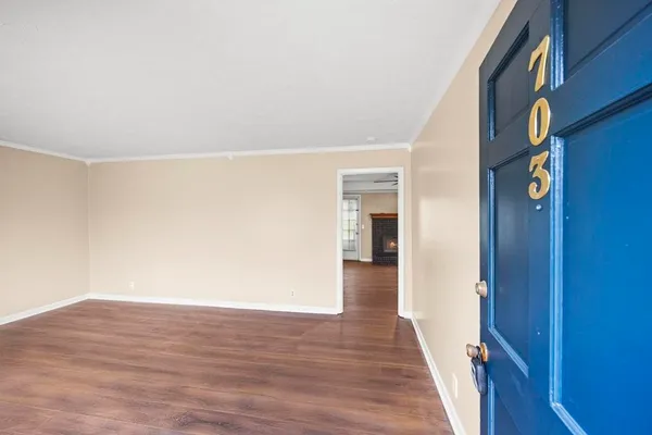 a view of hallway with wooden floor
