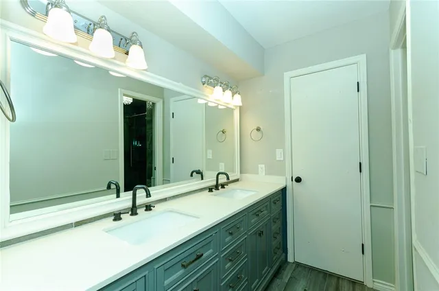 a bathroom with a double vanity sink mirror and double