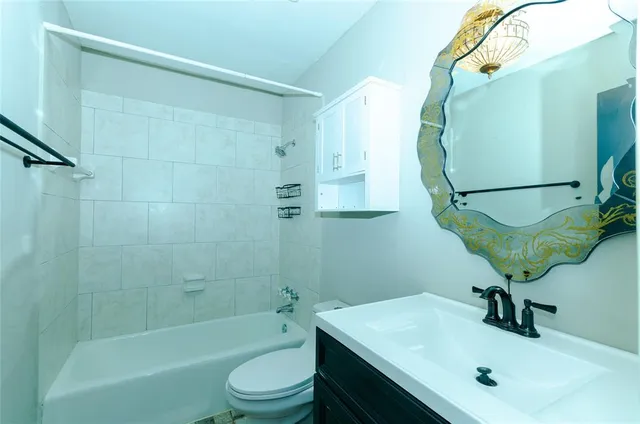 a bathroom with a sink a toilet and a mirror