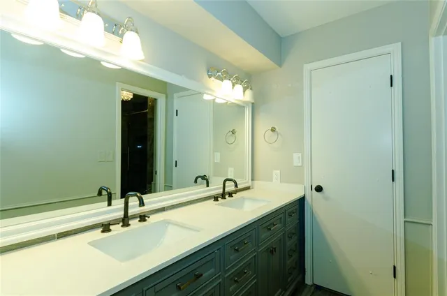 a bathroom with a double vanity sink and a mirror