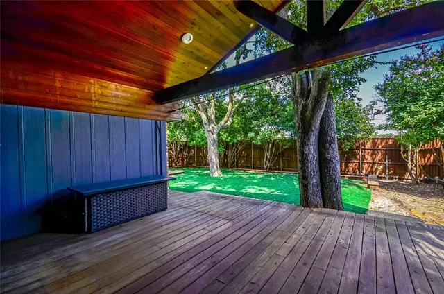 a view of a backyard with wooden floor and outdoor space