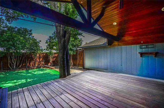 a view of a backyard with wooden fence