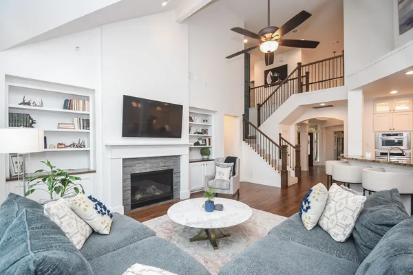 a living room with furniture a fireplace and a flat screen tv