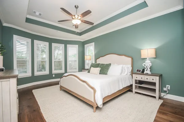 a large bedroom with a large bed and a chandelier