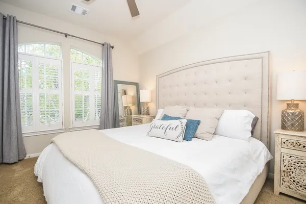 a bedroom with a large bed and a window