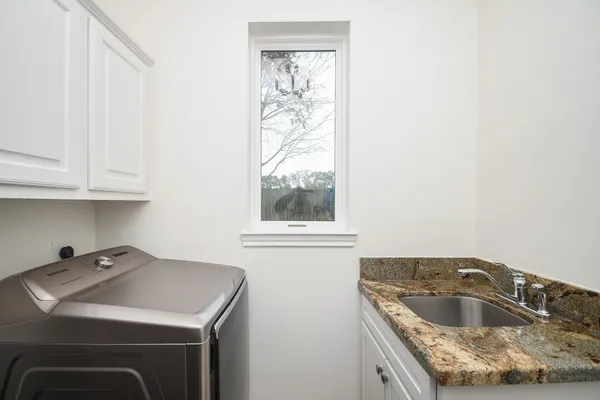 a kitchen that has a sink and a stove