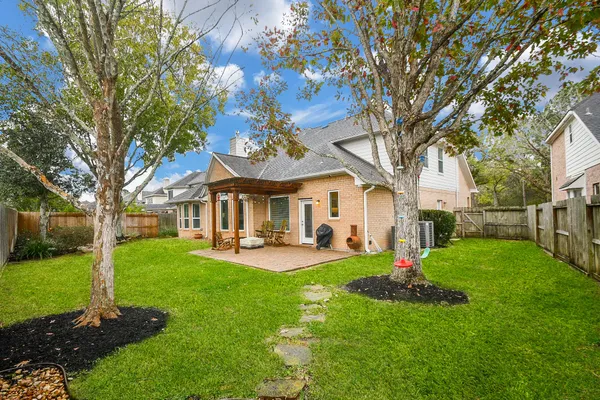 a front view of a house with patio and garden