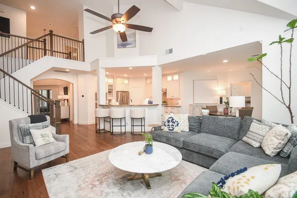 a living room with furniture and a dining table
