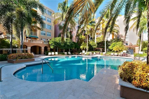 a swimming pool with outdoor seating and yard