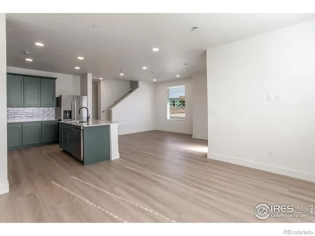 a view of kitchen with a sink and wooden floor