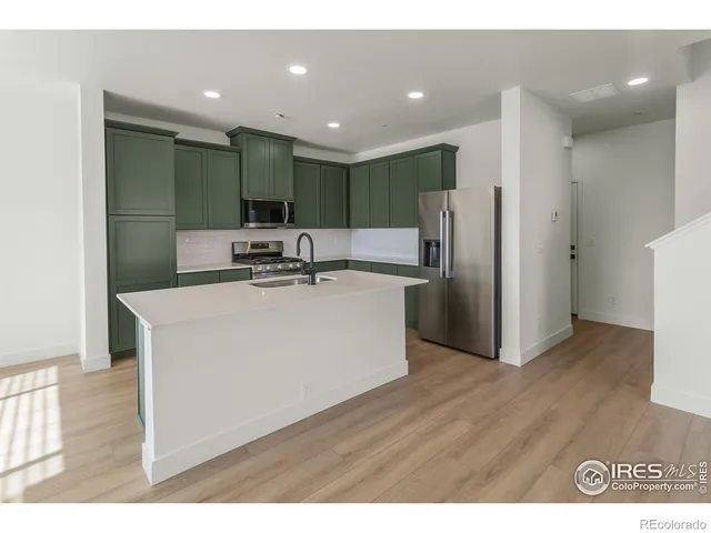 a kitchen with stainless steel appliances a refrigerator and a sink