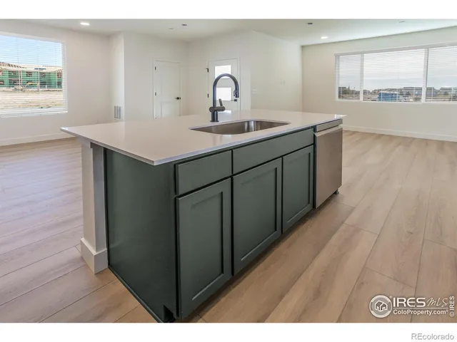 a kitchen with a wooden floor and a wooden floor