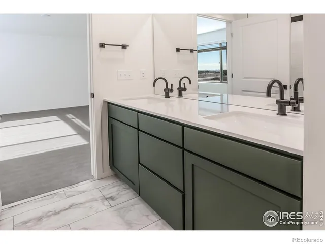 a en suite bathroom with a sink and mirror