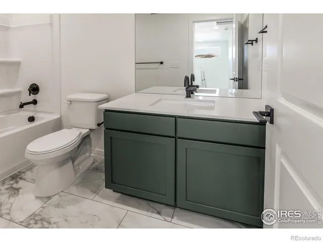 a bathroom with a sink toilet and mirror