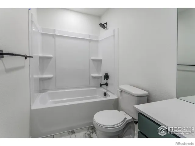 a bathroom with a toilet a sink and bathtub