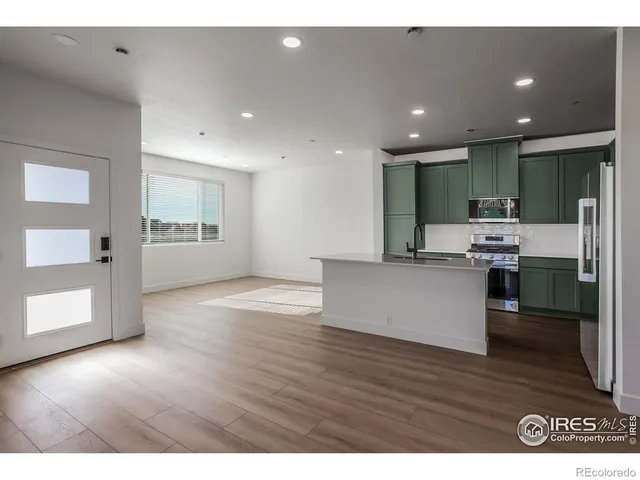 a view of kitchen with cabinets and wooden floor