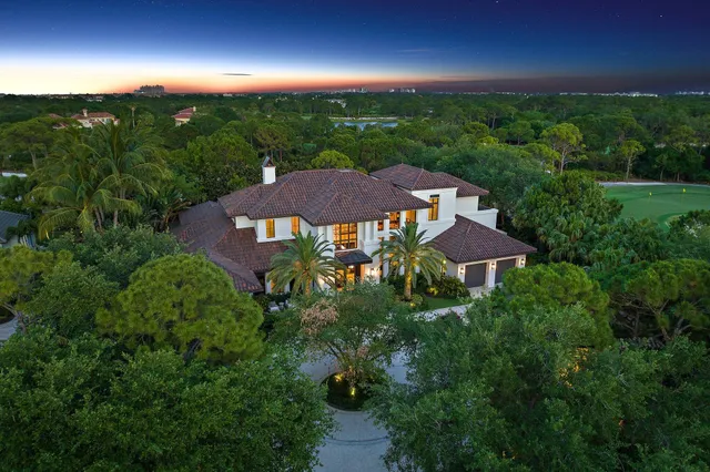 a living room with furniture and large windows
