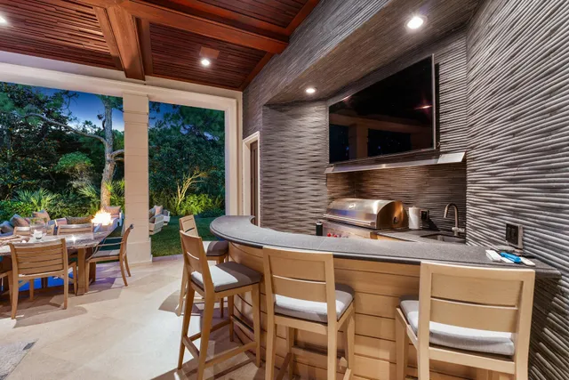 a bathroom with a granite countertop sink a toilet a mirror and a window