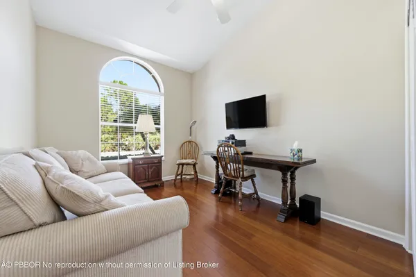 a view of a livingroom with workspace and a window