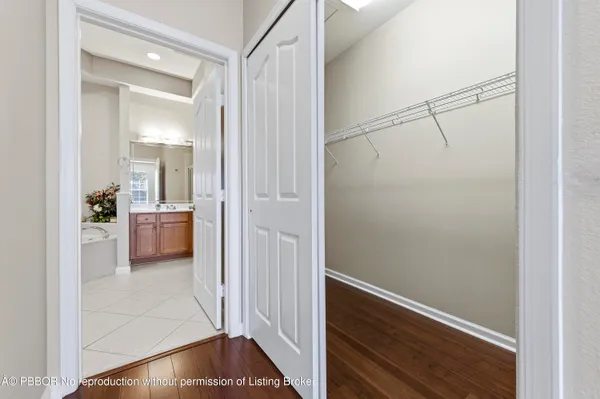 a view of a hallway and a livingroom with furniture