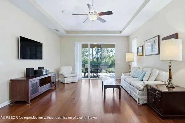 a living room with furniture flat screen tv and wooden floor