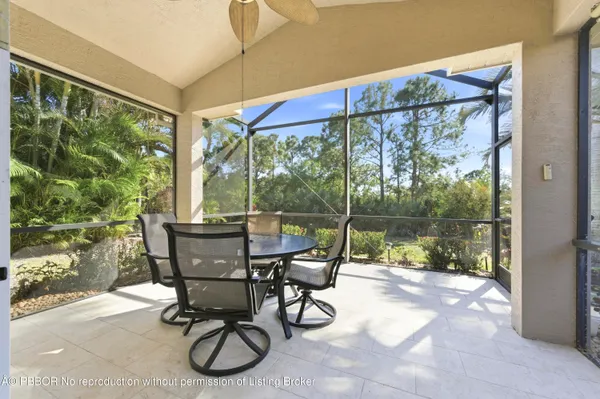 a view of a patio with table and chairs next to a yard