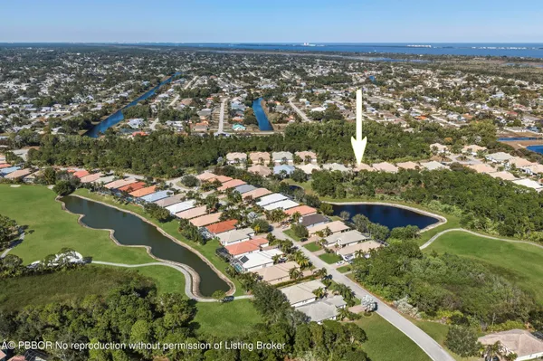 an aerial view of residential houses with outdoor space and river