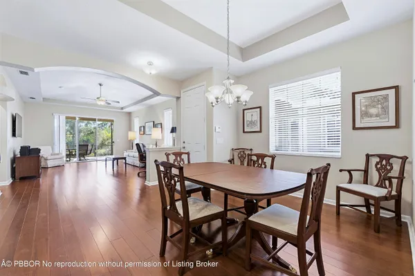 a dining room with furniture window and wooden floor