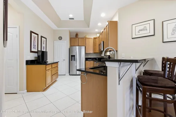 a kitchen with stainless steel appliances granite countertop a refrigerator and a stove top oven