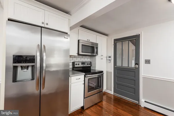 a kitchen with stainless steel appliances granite countertop a refrigerator and a stove top oven