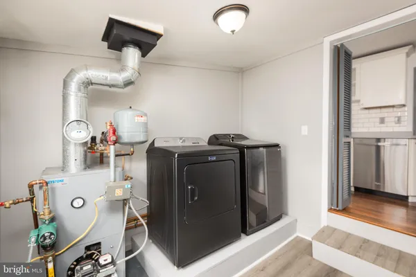 a kitchen with cabinets and a refrigerator