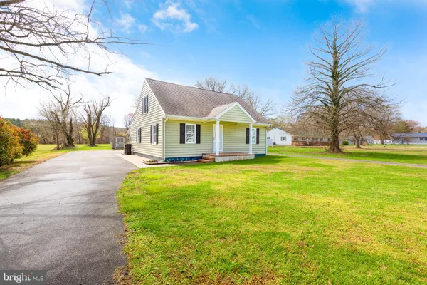 a view of house that has a big yard