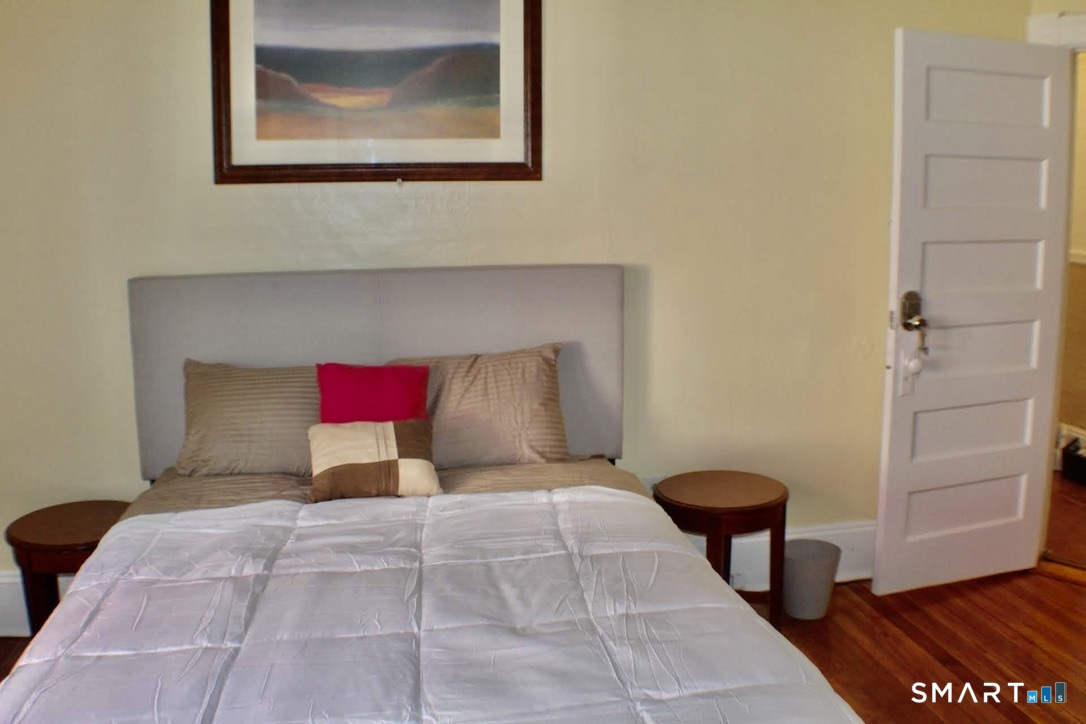150 Whitney Street Hartford, CT 06105 - Photo 22 of 39 a bed room with a bed and a painting on the wall