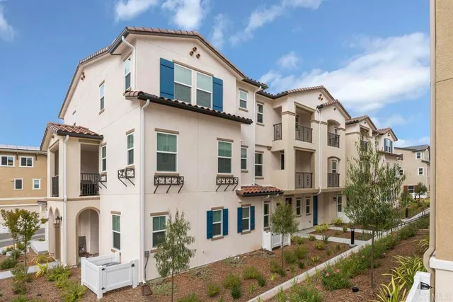 a front view of a residential apartment building with a yard