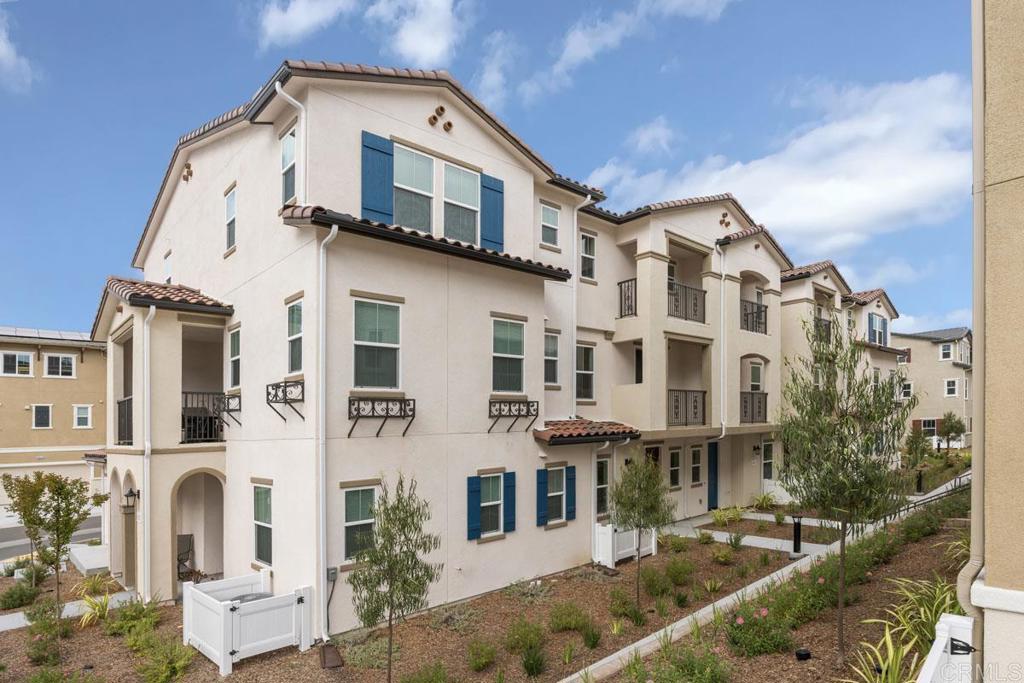 a front view of a residential apartment building with a yard
