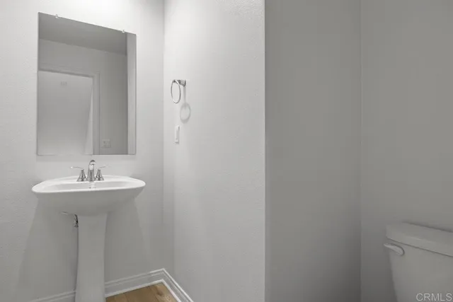 a bathroom with a sink a mirror and toilet