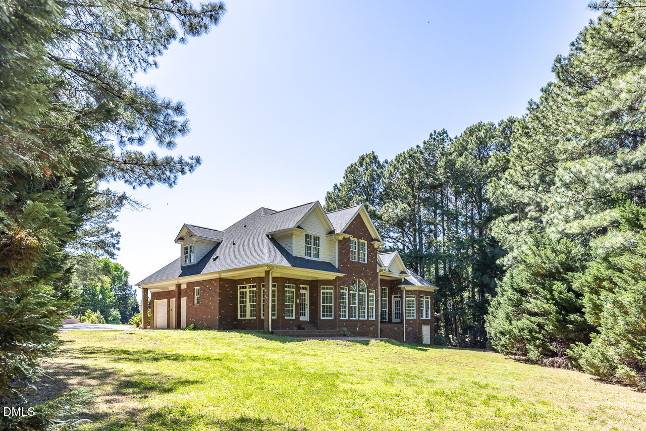 4004 Frontenac Court Apex, NC 27539 - Photo 54 of 61 a view of a large house with a large pool and large trees