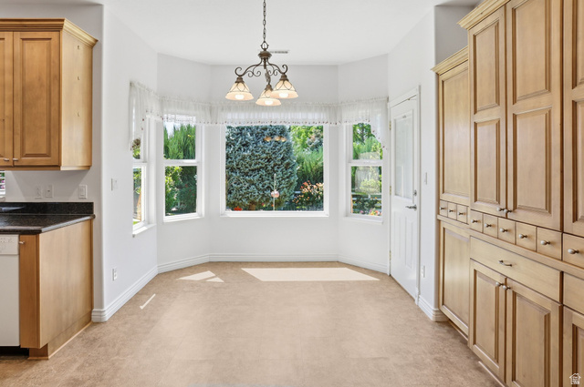 2190 750 West Perry, UT 84302 - Photo 15 of 42 Bay window dining area with a multi-light chandelier and carpet flooring