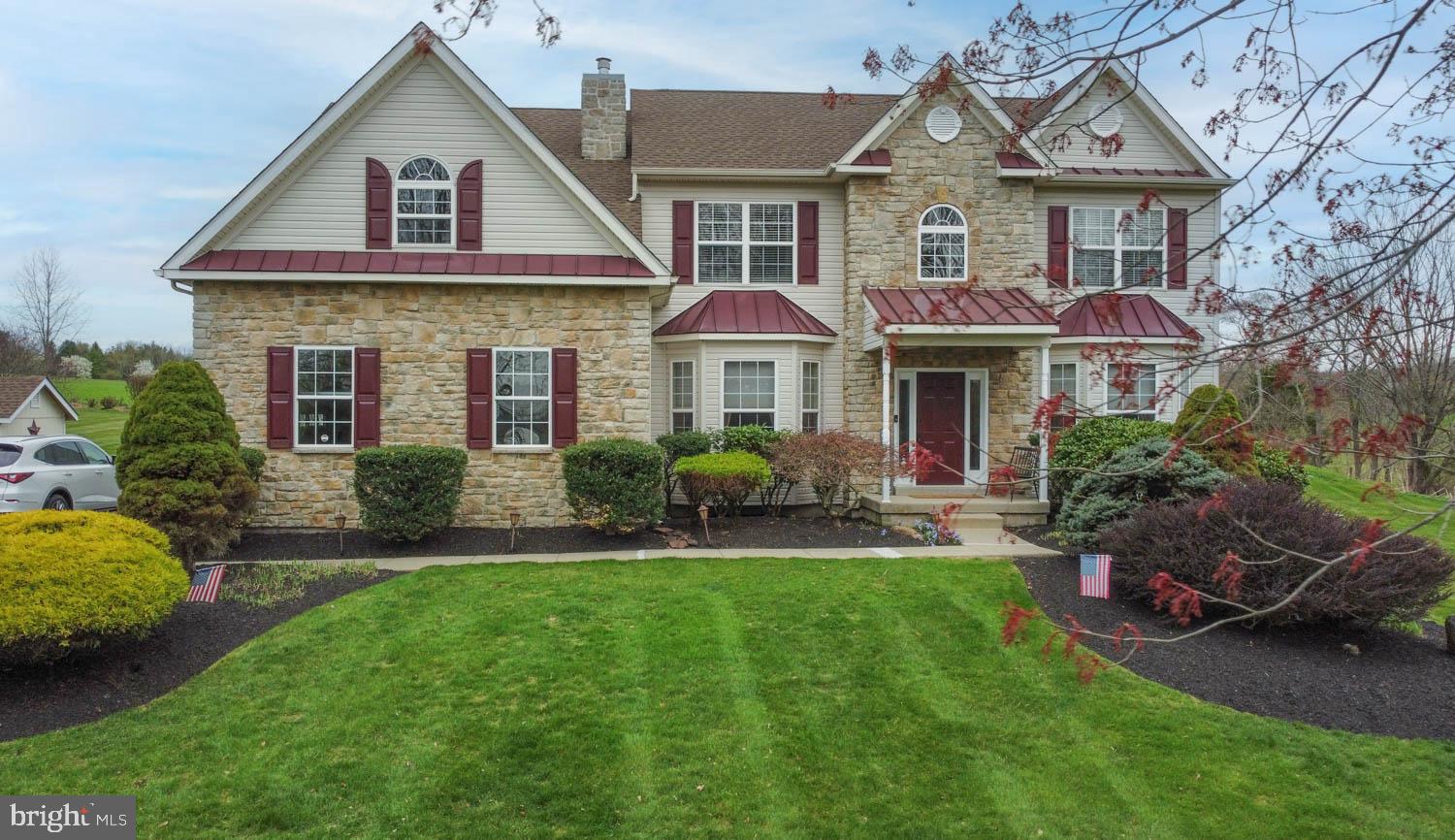1026 Creamery Road Perkasie, PA 18944 - Photo 1 of 45 a front view of a house with a garden and plants