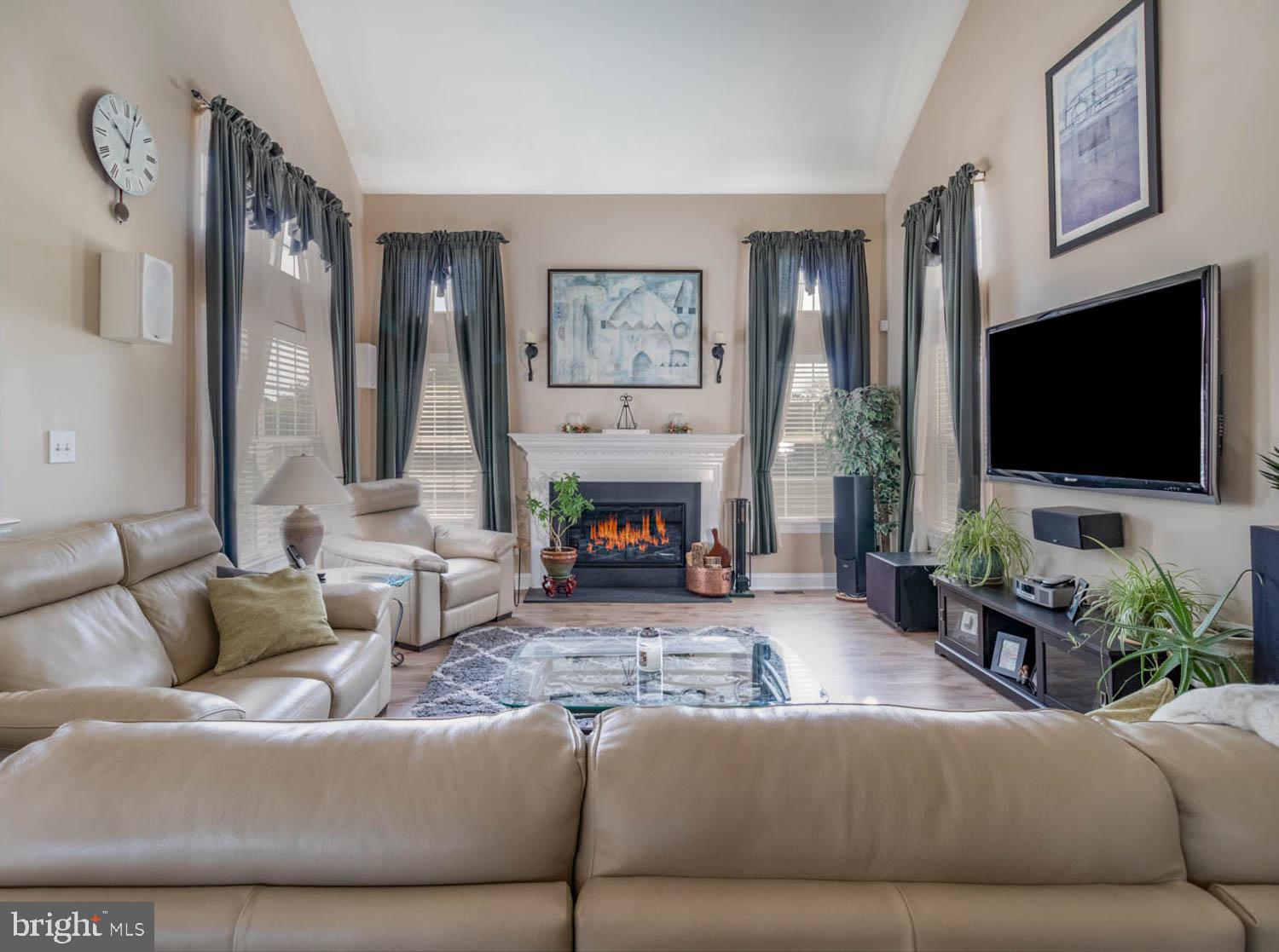 1026 Creamery Road Perkasie, PA 18944 - Photo 18 of 45 a living room with furniture a large window and a flat screen tv