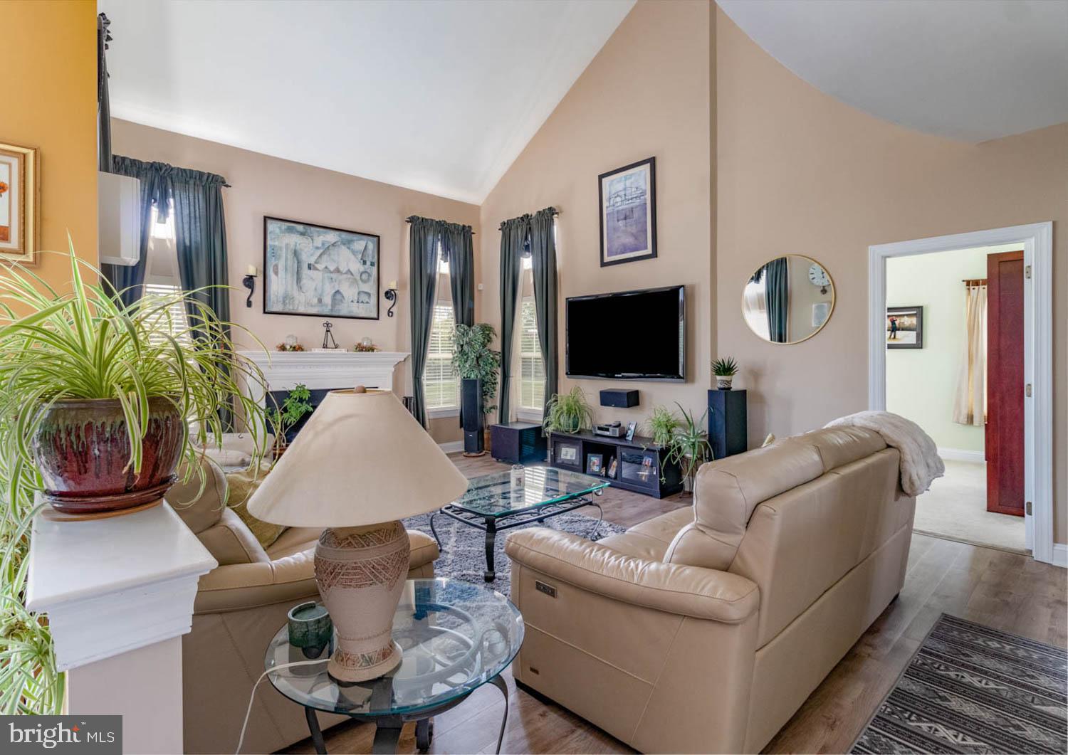1026 Creamery Road Perkasie, PA 18944 - Photo 20 of 45 a living room with furniture a flat screen tv and a wall painting
