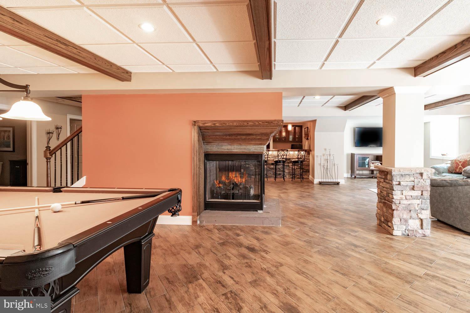 1026 Creamery Road Perkasie, PA 18944 - Photo 32 of 45 a lobby with furniture and a fireplace