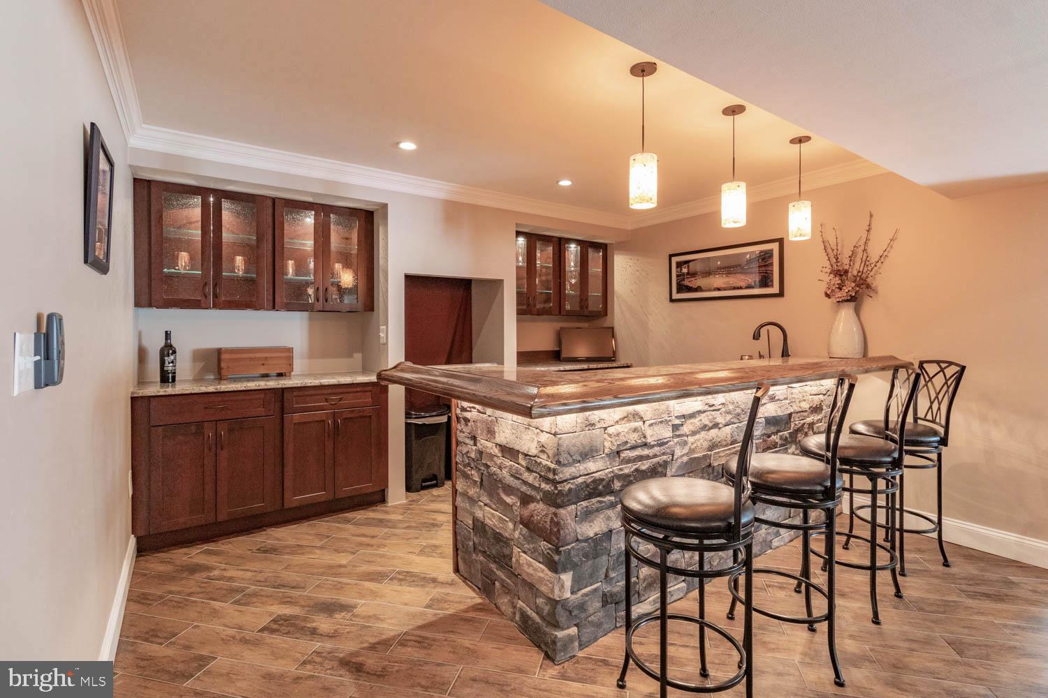 1026 Creamery Road Perkasie, PA 18944 - Photo 33 of 45 a kitchen with stainless steel appliances granite countertop a stove top oven a sink dishwasher and chairs with wooden floor